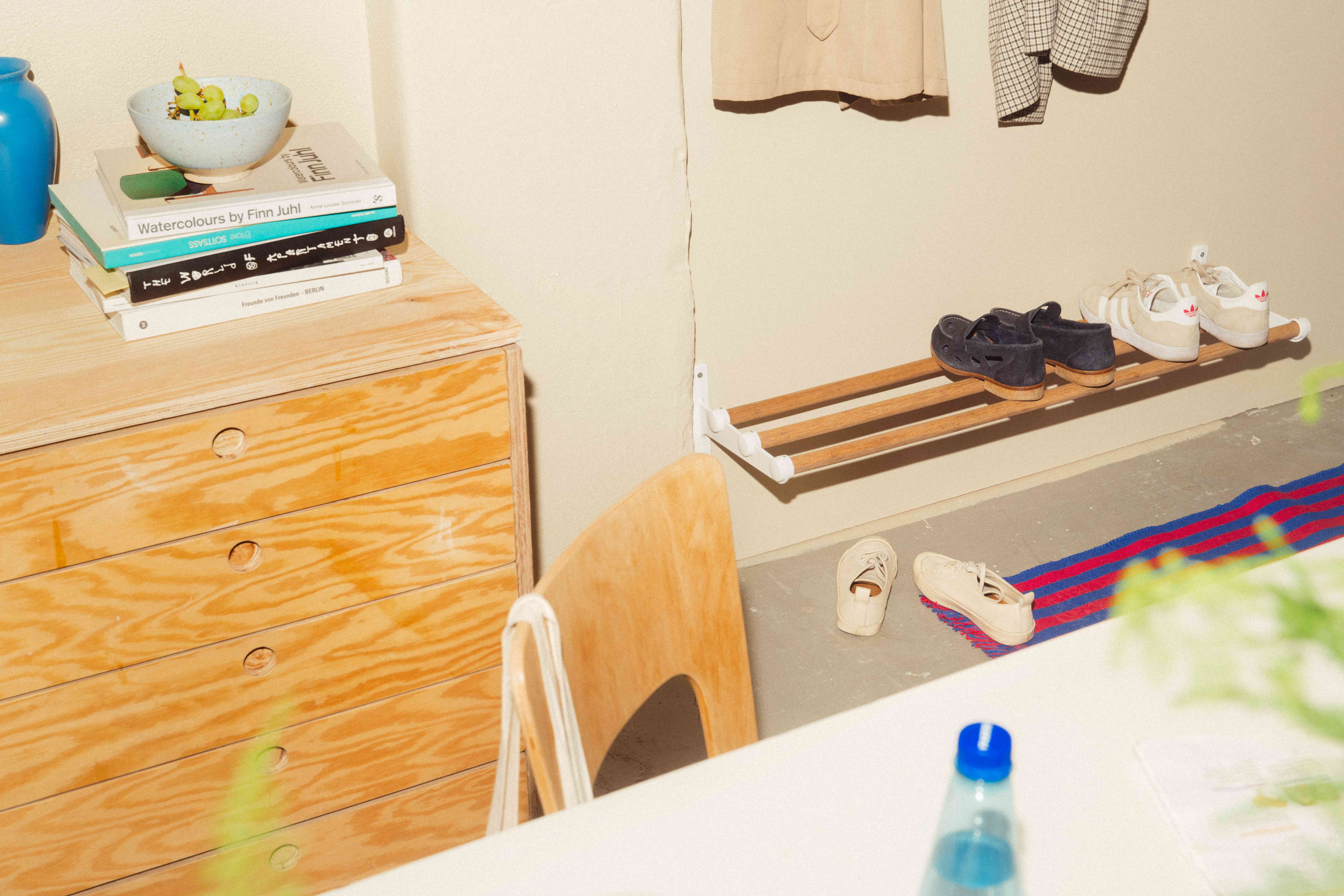 An industrial hallway with Nostalgi hat & shoe rack in marine bamboo and white used as a shoe rack